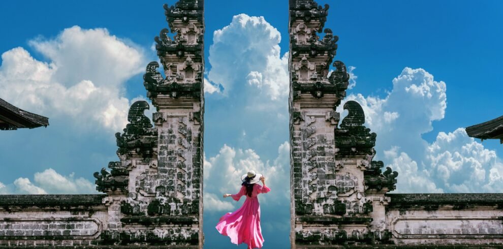 female-with-a-pink-dress-standing-at-temple-gates Bali