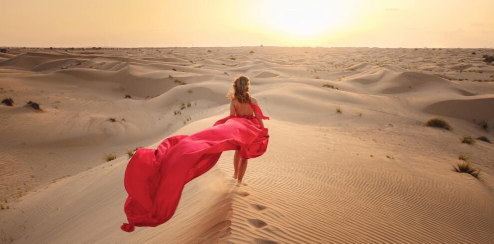 woman-in-sands-dunes-of-desert-at-sunset-2025-01-16-08-31-30-utc-min